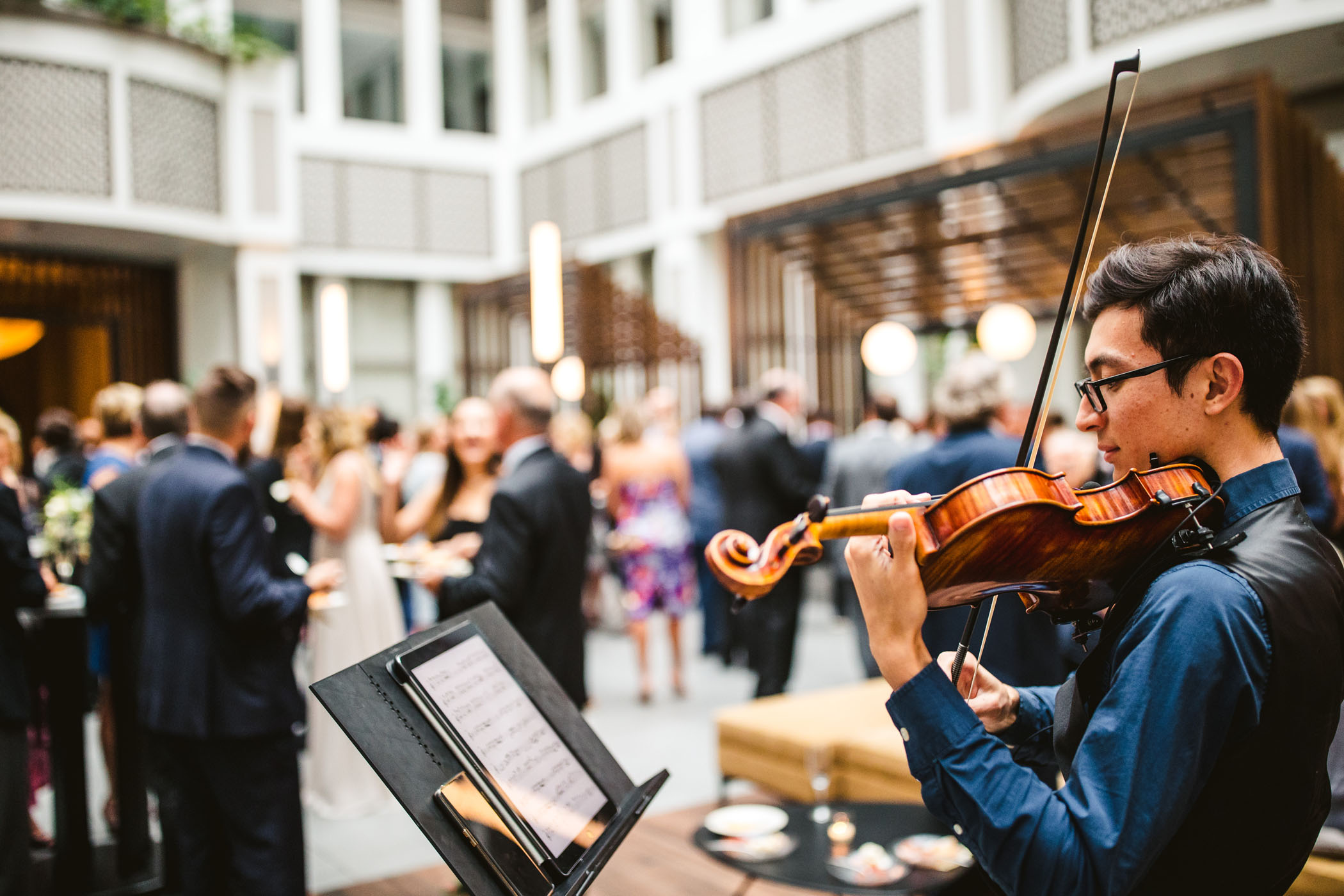 Violinist in Tokyo hired to perform music at a cocktail hour at a wedding.